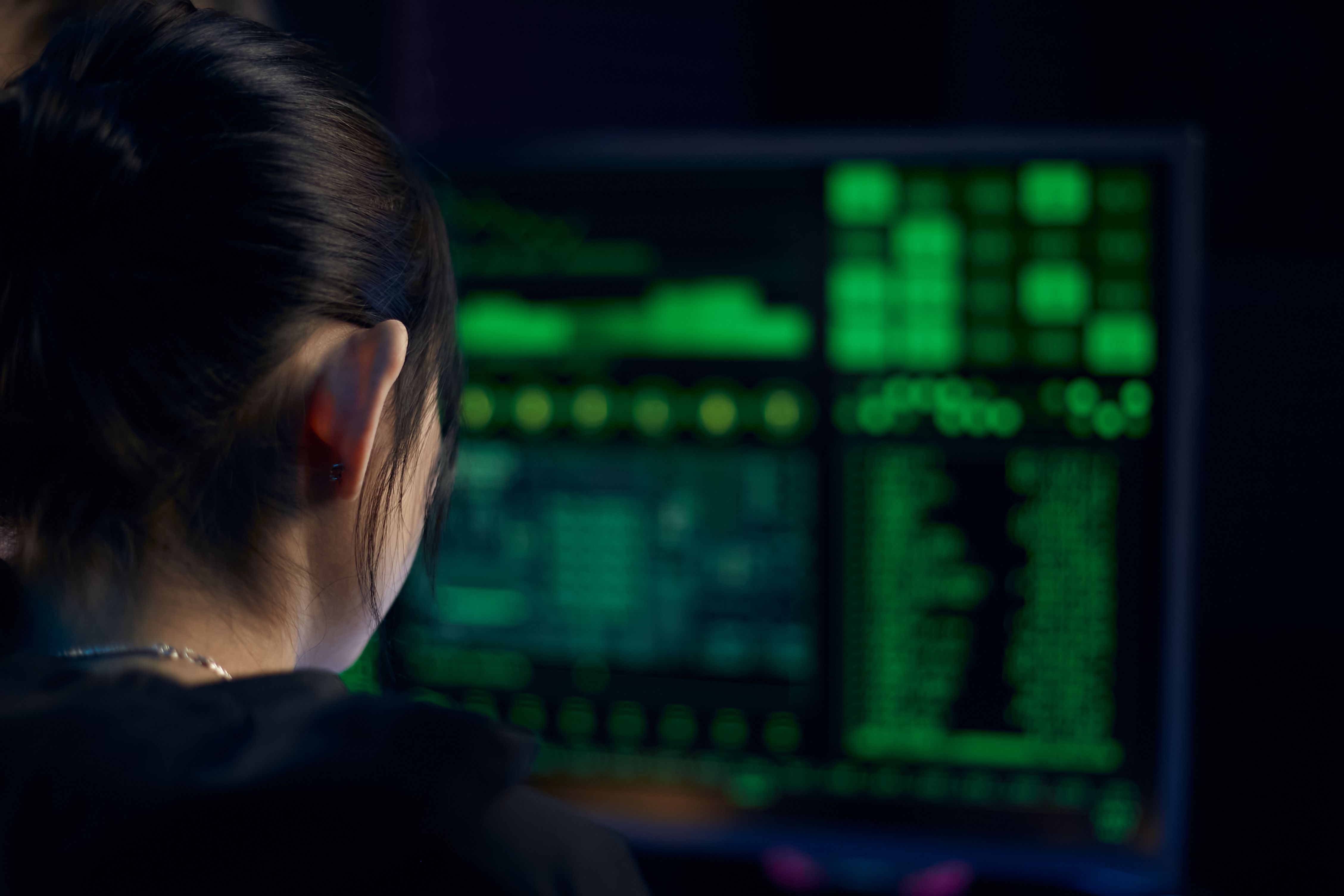 Security analyst reviewing system data on screen